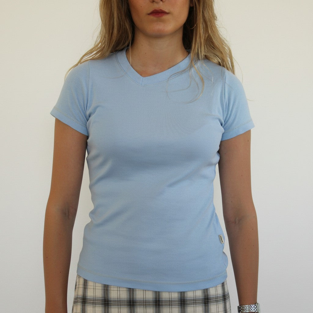 Model wearing a light blue AVÓ women t-shirt by wannabes* | Clothing Brand with a v-neck and short sleeves