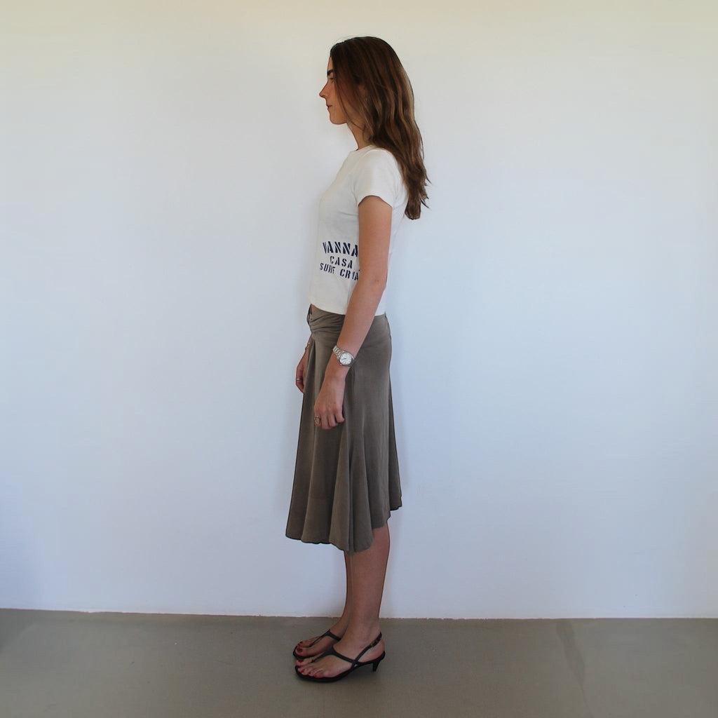 Woman wearing a white wannabes* | Clothing Brand Casa do Surf t-shirt with a brown midi skirt, side profile view